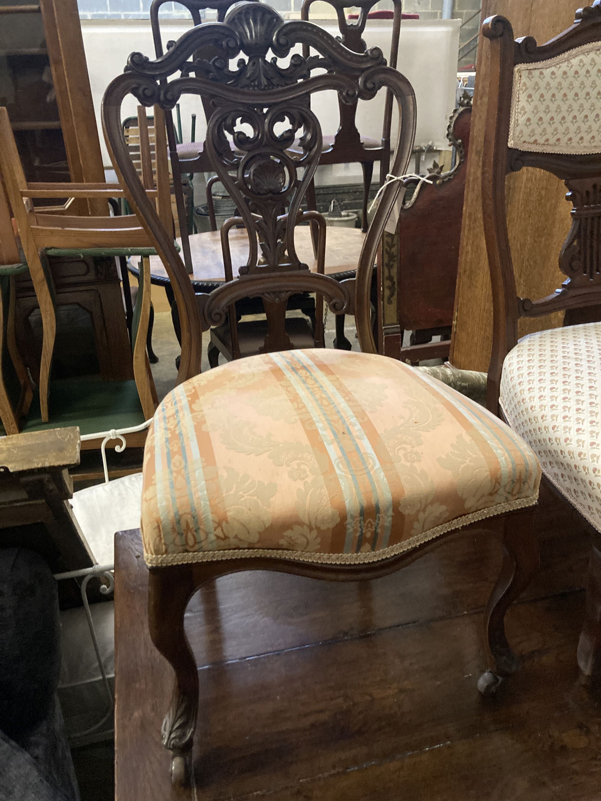 A pair of Victorian walnut dining chairs, on cabriole legs